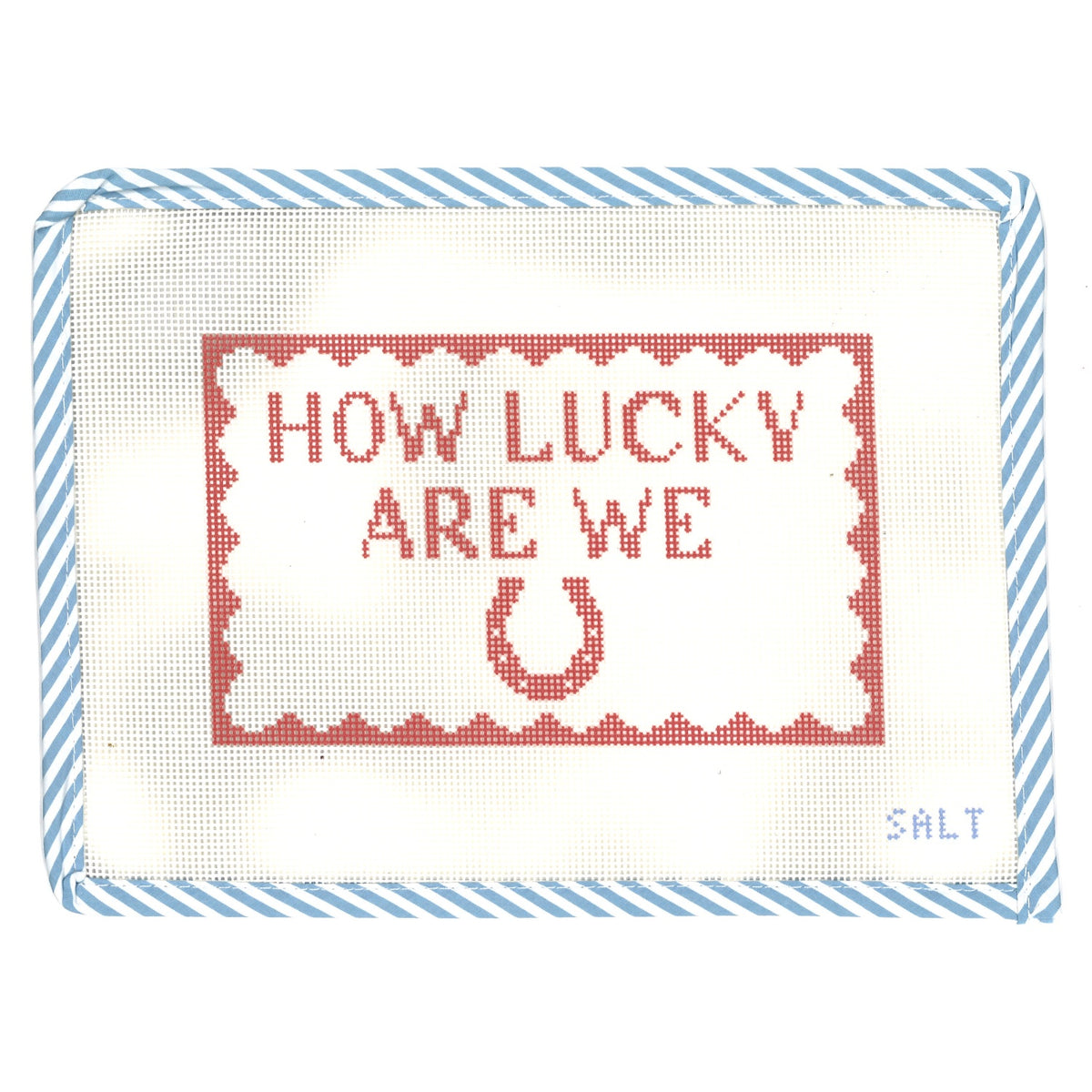 "How Lucky Are We" needlepoint canvas in red with a horseshoe motif and blue striped edge trim
